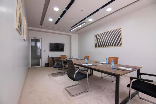 a conference room with a long table and chairs at Eseriani The Resort in Naivasha