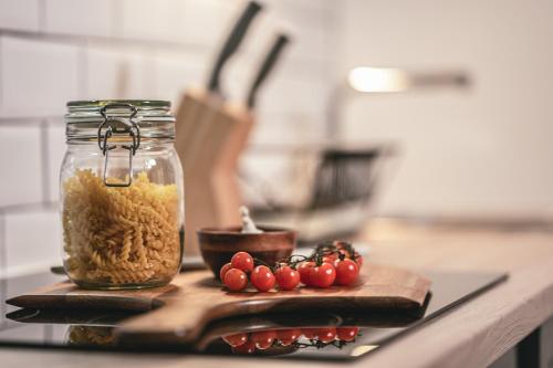 a jar of food and some tomatoes on a cutting board at The Gallery in Bad Ischl