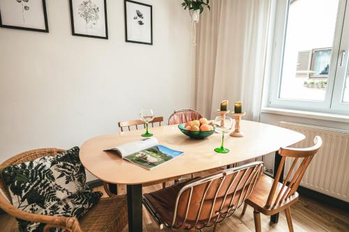 a dining room table with chairs and a bowl of fruit on it at The Gallery in Bad Ischl