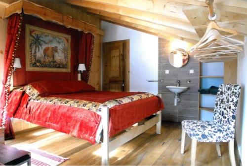 a bedroom with a bed and a chair and a sink at Chalet Grouse in Ayer