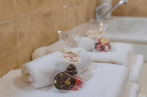 um grupo de toalhas com chocolates em cima de um lavatório em PROVENSÁLSKY RODINNÝ APARTMÁN MANDOLINA em Bojnice
