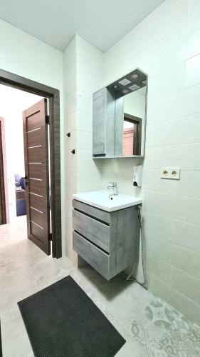 a bathroom with a sink and a mirror at BUGAZ GOLD апартаменти біля моря in Karolino-Buhaz