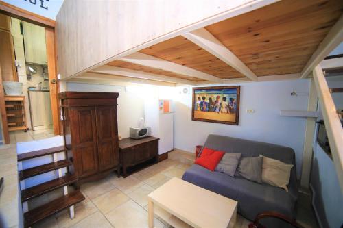 a living room with a couch and a table at Ahuzat Shaul - Apartment in H̱adera