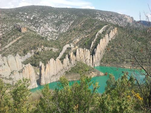 a view of a mountain with turquoise water at Hotel Boutique Bodegas De Arnes - Adults Only in Graus