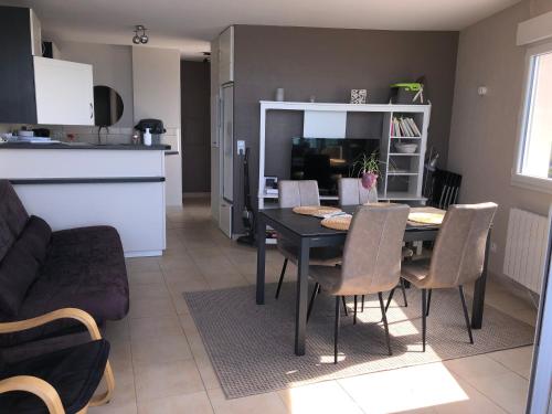 une cuisine et une salle à manger avec une table et des chaises dans l'établissement Cap Eden 4 personnes, à Saint-Jean-de-Monts
