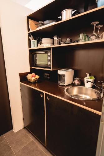 a kitchen with a sink and a microwave at The Gallery in Bad Ischl