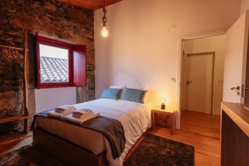 Ένα ή περισσότερα κρεβάτια σε δωμάτιο στο Casa Gaveto