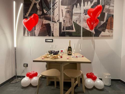 a table with red and white balloons and a bunch of hearts at Elite Apartment SPA in Catania