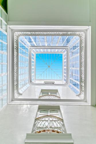 a room with a large window in a building at Genteel Home Plaza de España Cádiz in Cádiz