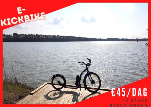 a bike parked on a dock next to a lake at Vakantiewoning in Mol centrum met eigen bar "CasaCuriosa" in Mol