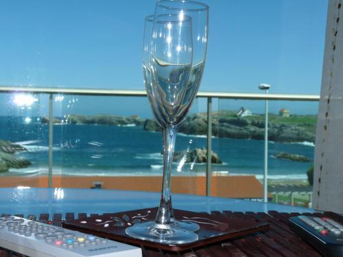 a wine glass sitting on top of a table at Apartamentos Maradentro in Soto de la Marina