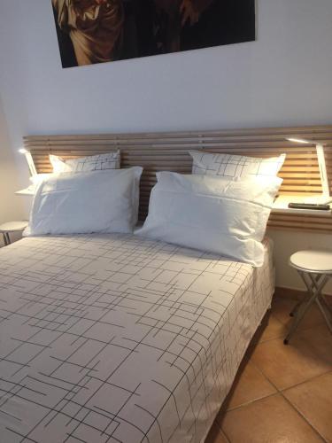 a bedroom with a bed with white sheets and pillows at CasaTua in Amalfi