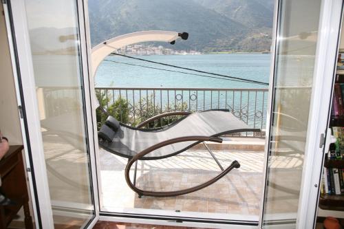 a glass door with a view of the water at Apartments Pejanović in Kotor