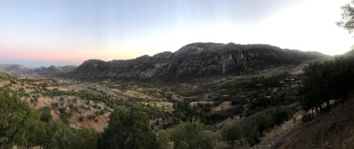 a mountain view of a valley with trees and mountains at Hotel Euphrat Nemrut in Karadut