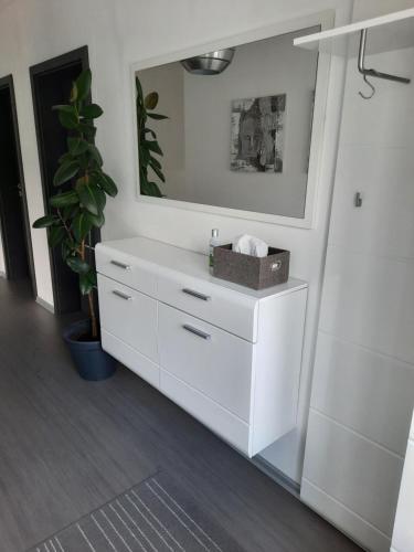 a white dresser with a mirror in a room at Ela Apartment Vilová in Skalná