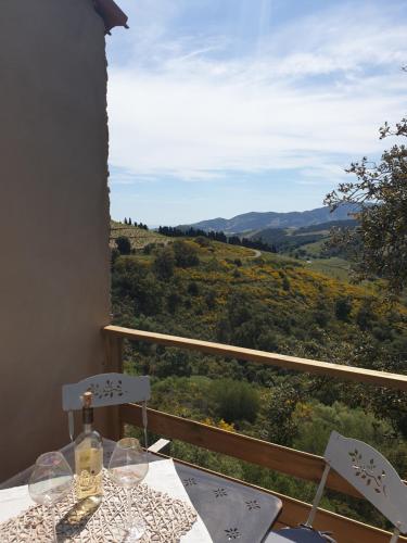 a table and chairs with a view of a valley at Mas del Roumany in Port-Vendres