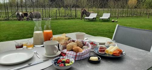 a table with a plate of food on a table at La Buse in Koekelare