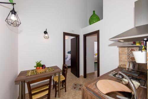 a kitchen with a table and a dining room at YourHome - Casa Marina Positano in Positano