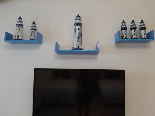 a shelf with three figurines of a lighthouse at 八畝田 Bamutian Farmland 8 Mu in Yuli