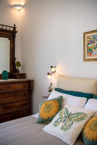 a bedroom with a bed with pillows and a dresser at YourHome - Casa Marina Positano in Positano