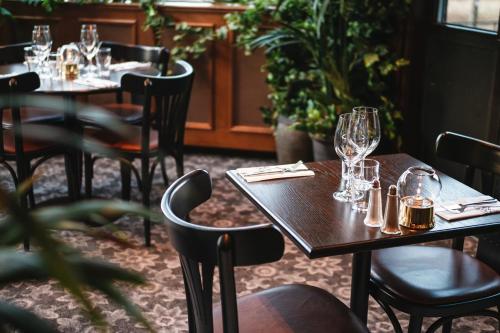 a restaurant with tables and chairs with wine glasses at Elite Hotel Brage - Hotel & Spa in Borlänge