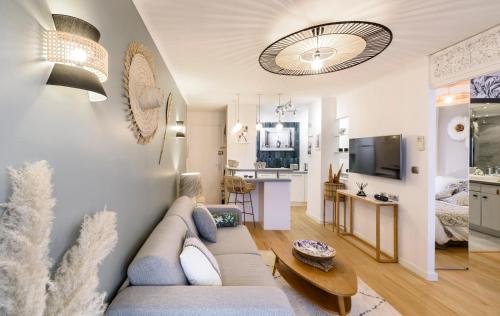 a living room with a couch and a tv at Host Inn Sweet Croisette in Cannes