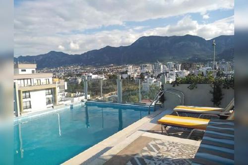 a large swimming pool on top of a building at Aqua Royal Holiday Apartments Girne in Kyrenia
