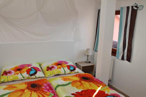 a bedroom with a bed with flowers on it at Attic with parking, near the center of ČB - 110m2 in České Budějovice