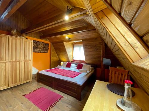 a bedroom with a bed in a room with an attic at Vila Viktoria in Štôla