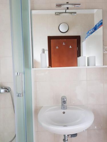 a bathroom with a sink and a mirror at Relax Zone III in Malinska
