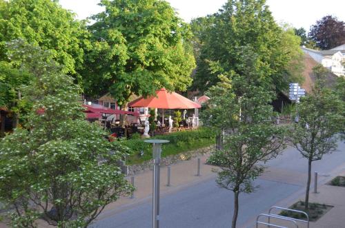 a view of a street with a restaurant and trees at Appartementanlage Villa Granitz 45 in Göhren