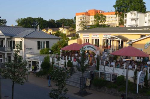 an overhead view of a town with people sitting outside a restaurant at Appartementanlage Villa Granitz 45 in Göhren
