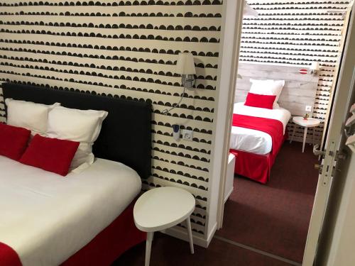 Postel nebo postele na pokoji v ubytování Hôtel Concorde