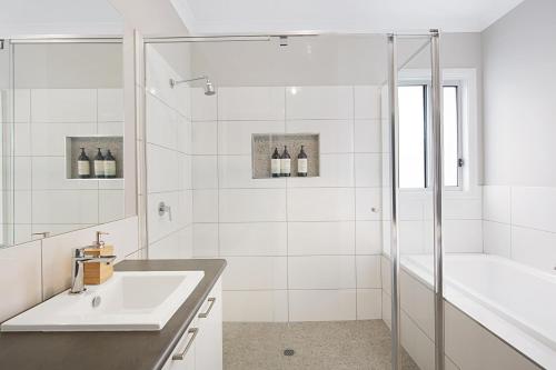 a white bathroom with a sink and a shower at Milawa Vineyard Views - Guesthouse 1 in Milawa