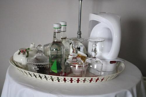 a tray of wine bottles and glasses on a table at New Park Hotel Athenry in Athenry