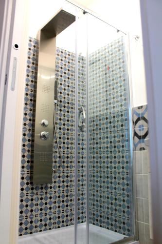 a shower with a glass door and a mirror at B&B I Krotoniati in Crotone