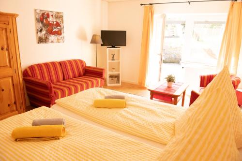 a living room with two beds and a couch at Landgasthof Nüchel in Malente