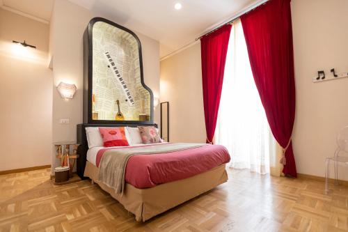 a bedroom with a bed with red curtains and a mirror at City Soul B&B in Naples