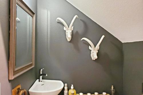 a bathroom with a sink and two bunny heads on the wall at 3652 Francis Street in Port Orange
