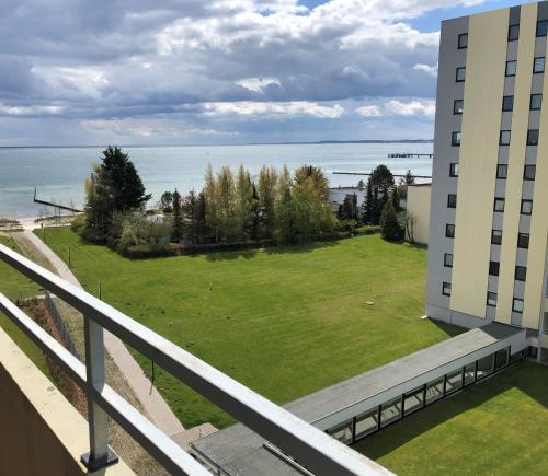 a view from the balcony of a building with a green lawn at Vier Jahreszeiten 2-53 in Großenbrode