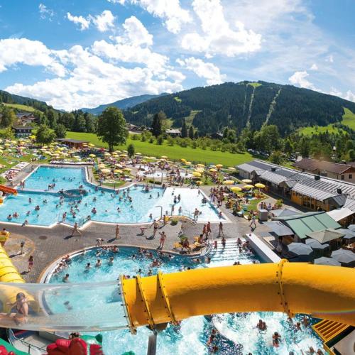 a large swimming pool with people in it at M4 Appartements in Wagrain