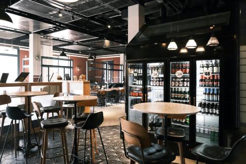 a bar with tables and chairs in a restaurant at URSIDE Hotel Shanghai The Bund in Shanghai