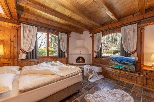 a bedroom with a bed and a fireplace at Chalet Mountain Plaza - Apt Garden in Pinzolo
