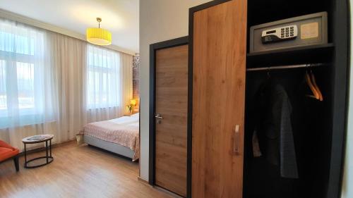 a room with a bedroom with a bed and a door at Hotel Atlas Halle in Halle an der Saale