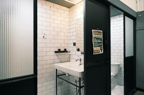 a bathroom with a sink and a toilet at URSIDE Hotel Shanghai The Bund in Shanghai