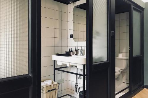 a bathroom with a sink and a toilet at URSIDE Hotel Shanghai The Bund in Shanghai