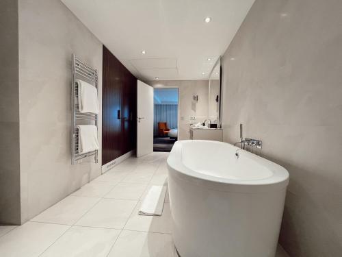 a bathroom with a large white tub in a room at Maison Pic in Valence