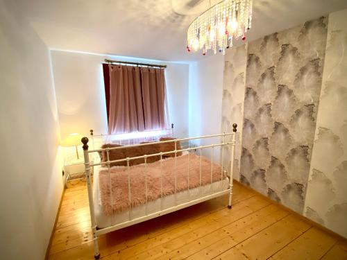 a bedroom with a crib in a room with a window at Apartament Monroe in Ustrzyki Dolne