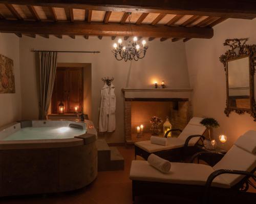 a bathroom with a bath tub and a fireplace at Borgo Petroro in Todi