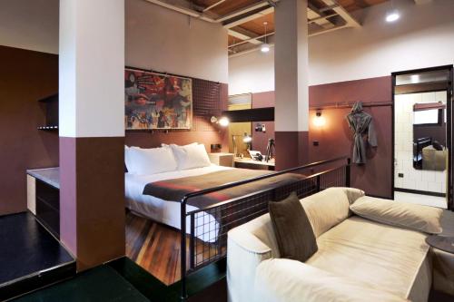 a hotel room with a bed and a couch at URSIDE Hotel Shanghai The Bund in Shanghai